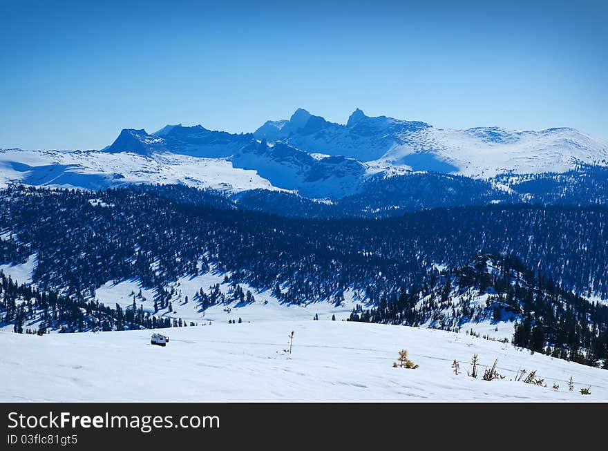 Beautiful Siberian landscape with snowy mountains and forest. Beautiful Siberian landscape with snowy mountains and forest.