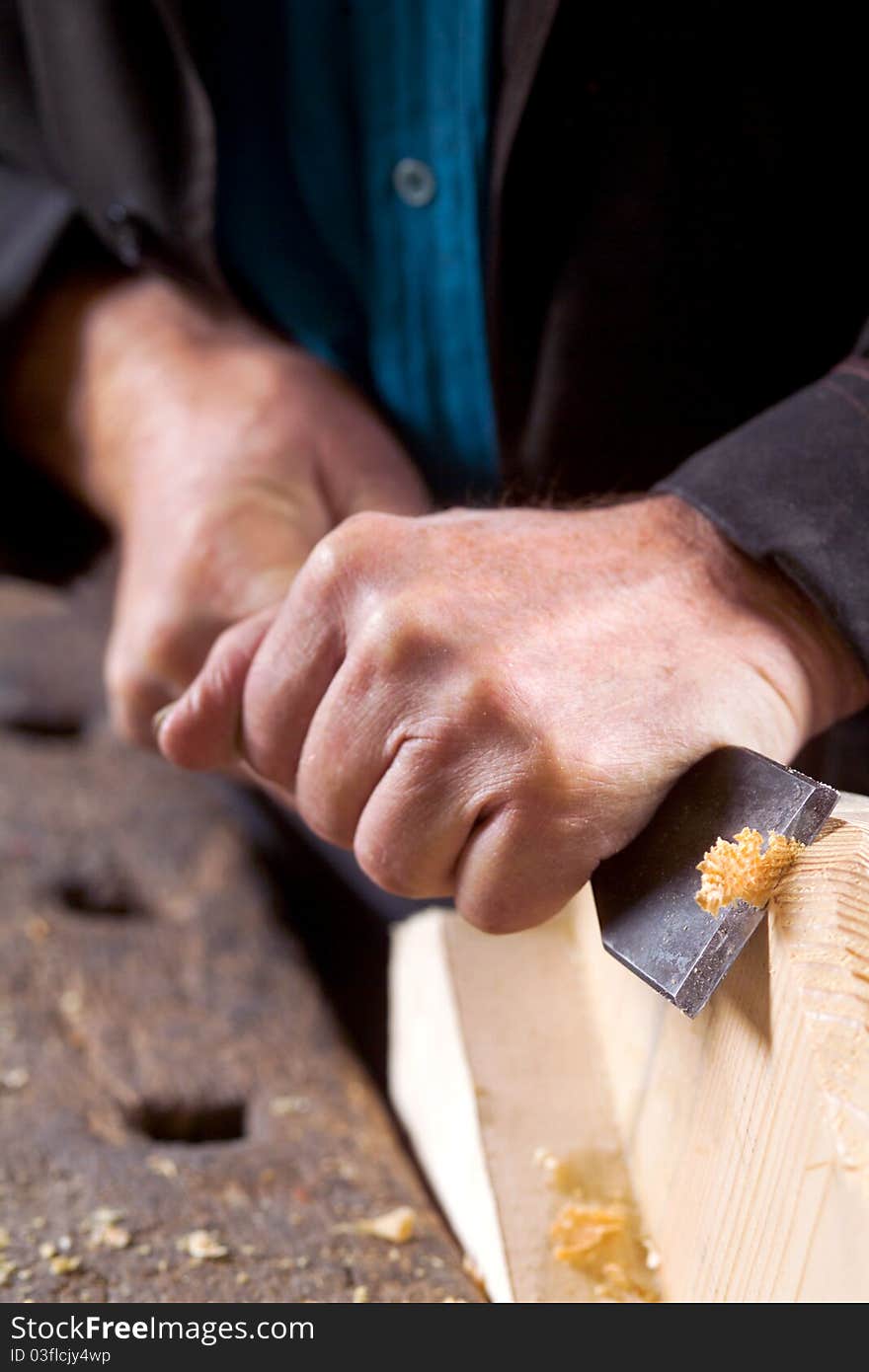 Hands working with a tool for processing boards