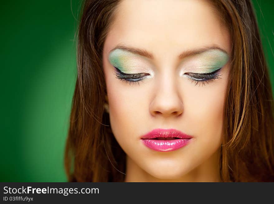 Portrait of a pretty girl on the green background