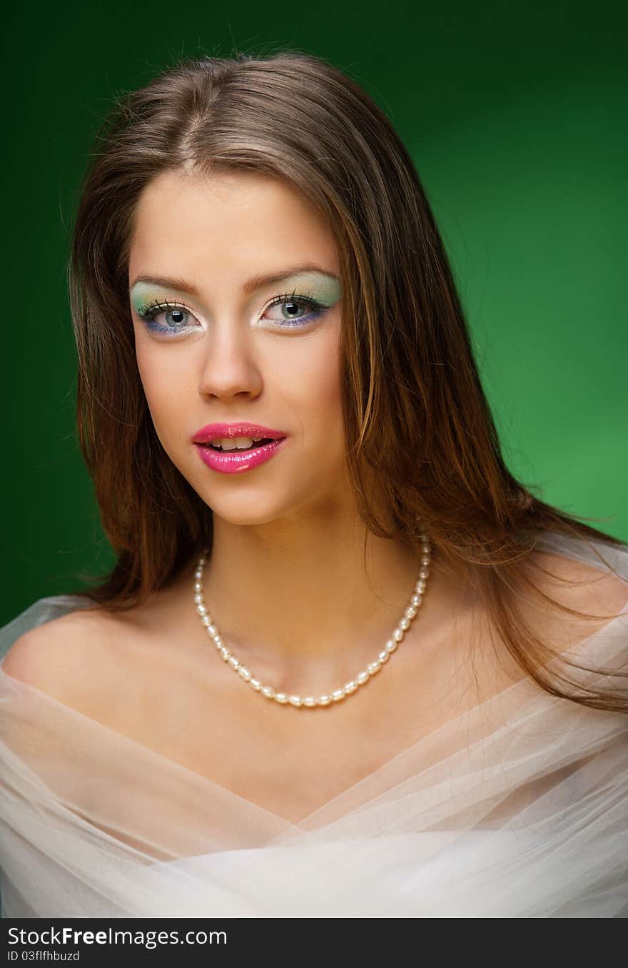 Portrait of a pretty girl on the green background