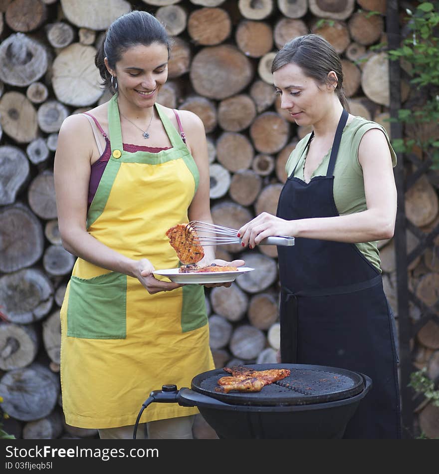 Barbecue Women In The Garden Having Fun