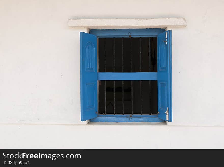 An old blue window and white wall in an Indian Village