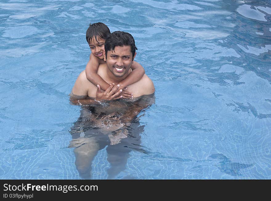 Father and Son having fun at the resport pool. Father and Son having fun at the resport pool