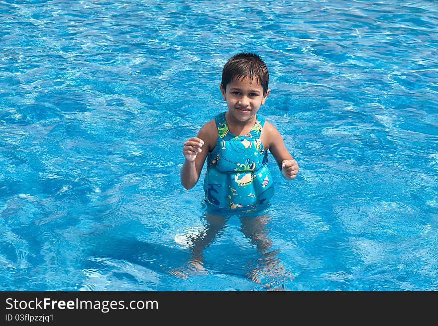 A handsome Indian kid playing in the pool. A handsome Indian kid playing in the pool