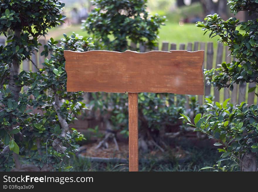 A wooden board on a local park with space for text