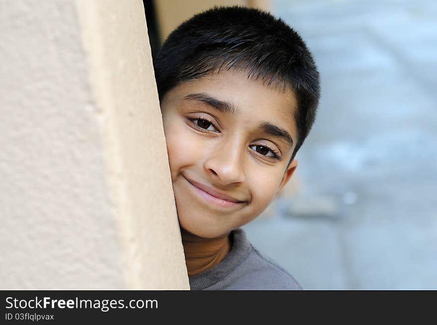 An handsome young indian man posing for the camera. An handsome young indian man posing for the camera