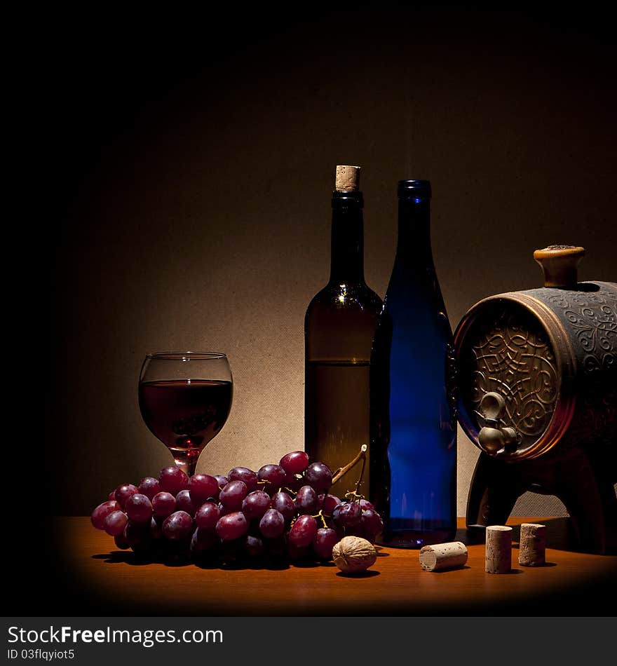 Wine composition (glass, bottle, grapes on yellow background)