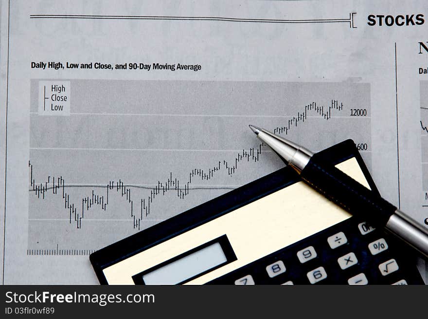 Rising stocks and calculator indicating business finance growth