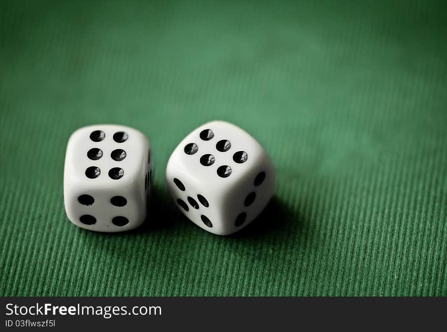 Close up with a pair of dices on green background