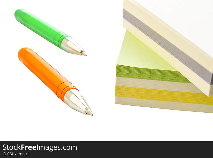 Ball pens and paper for records on the white isolated background