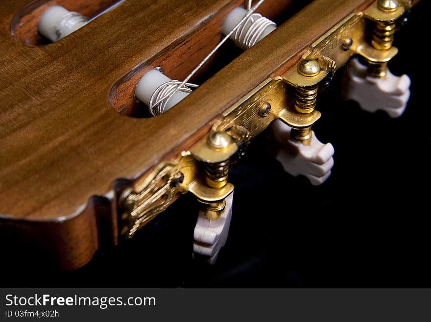 Headstock classic craftsman guitar isolated on a black background. Headstock classic craftsman guitar isolated on a black background