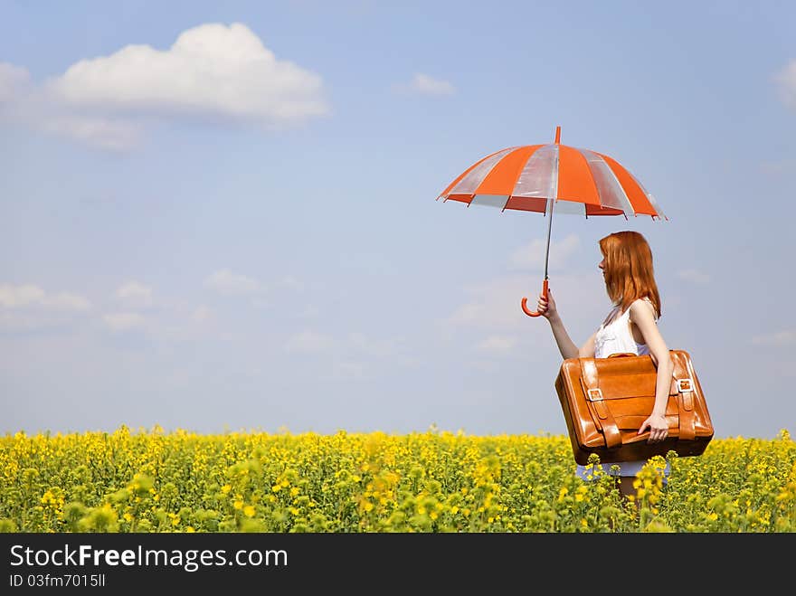 Redhead enchantress with umbrella