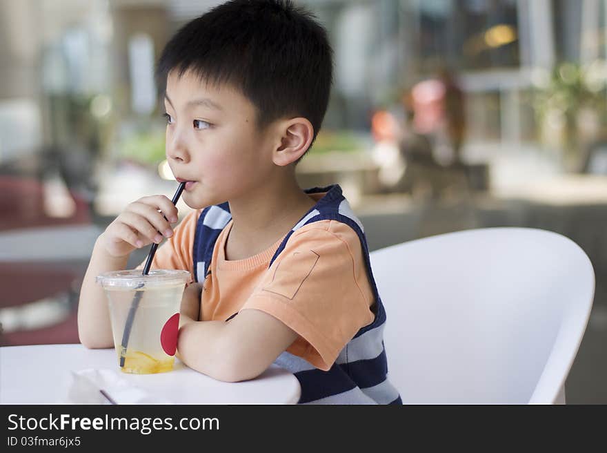 A Chinese boy drinking at a cafe