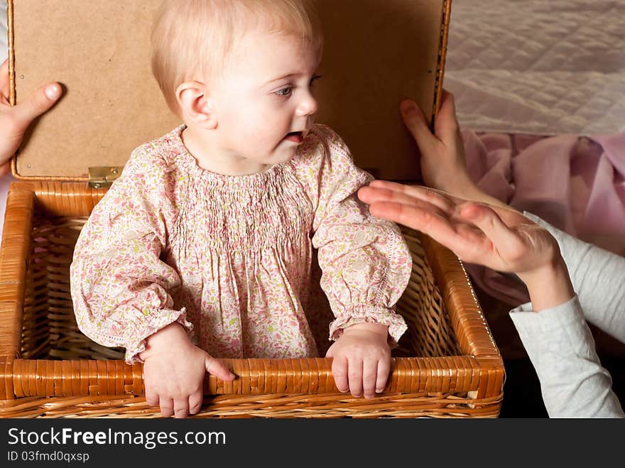 Closeup portrait of little cute baby girl in basket. Closeup portrait of little cute baby girl in basket