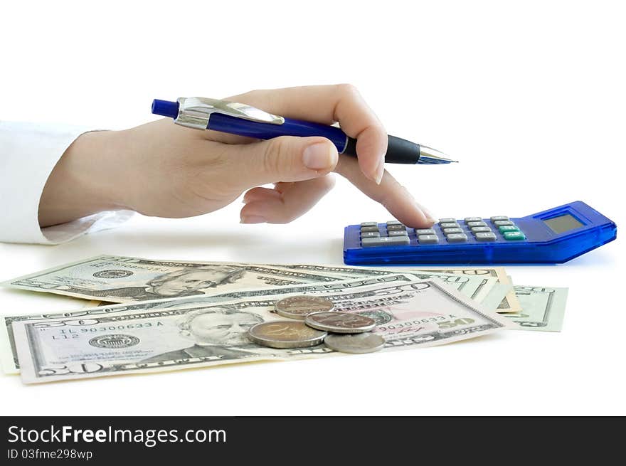 Hand with pen counting on the calculator and dollars on the table isolated on white