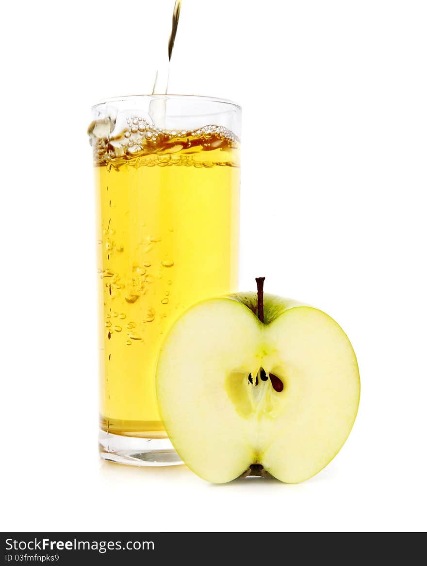 Glass of apple juice and half of apple on a white background. Glass of apple juice and half of apple on a white background