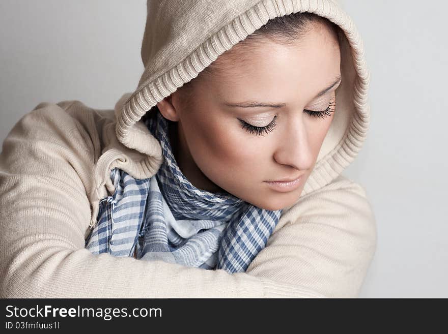 Shoot of a beautiful and sensual woman wearing a hood and looking down. Shoot of a beautiful and sensual woman wearing a hood and looking down