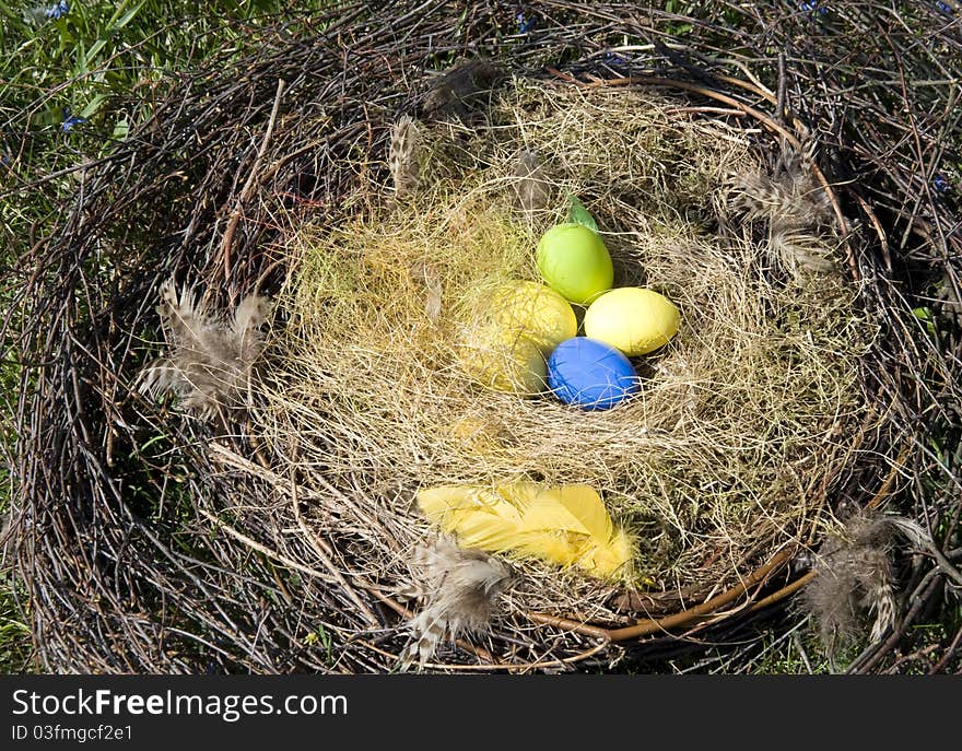 Colored Easter eggs in a nest in the spring