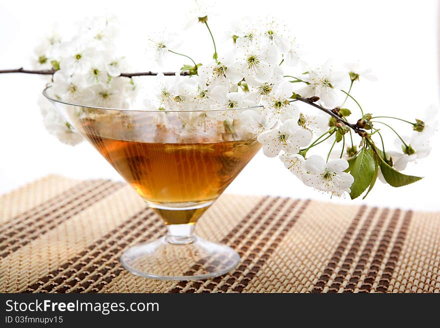 Bowl green tea and a branch with colors on a support. Bowl green tea and a branch with colors on a support