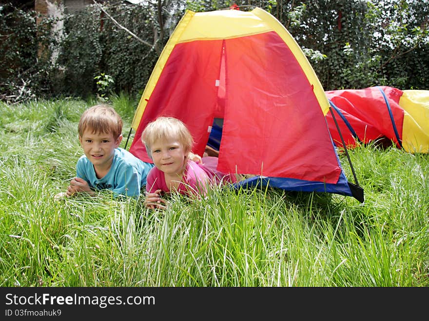 Young brother and sister in colorful tent