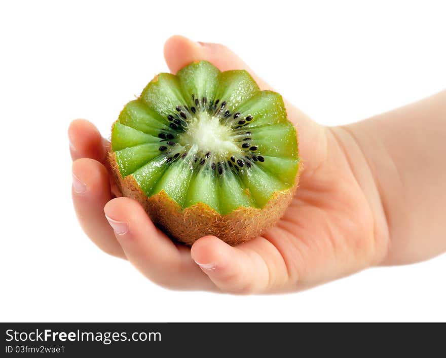 Child hand holds kiwi in hand. Child hand holds kiwi in hand