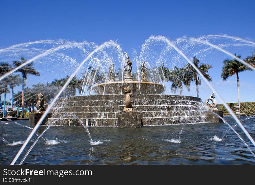 Water sprays and flows over the fountain brick work