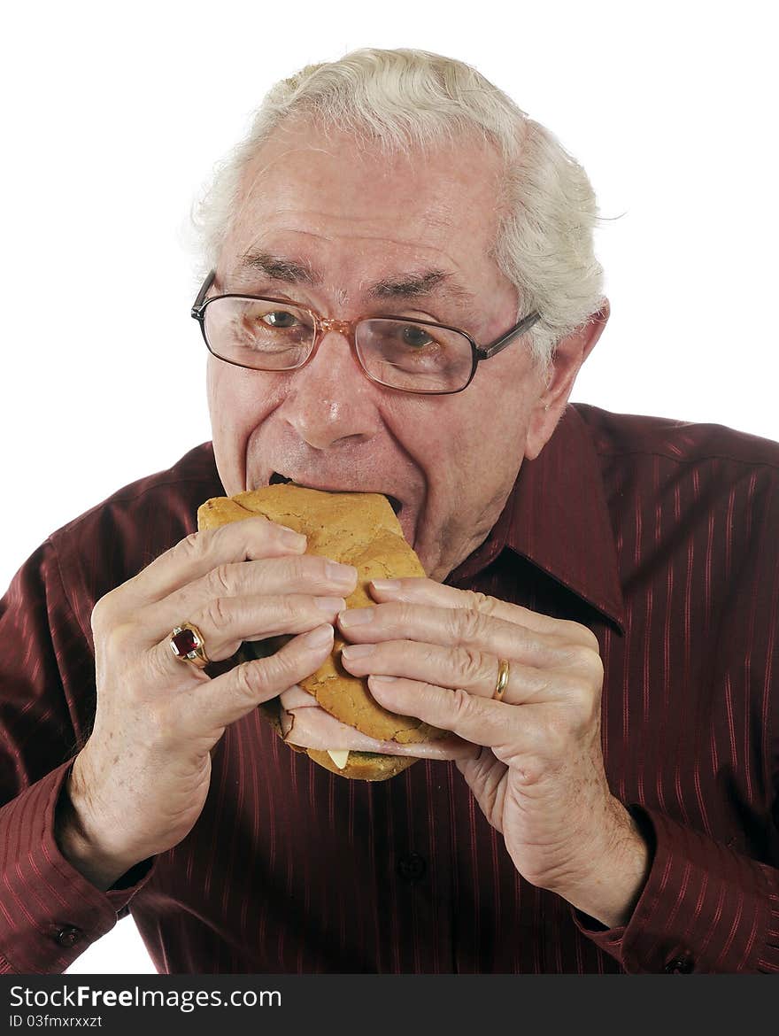 A senior man enjoying a great submarine sandwich. A senior man enjoying a great submarine sandwich.