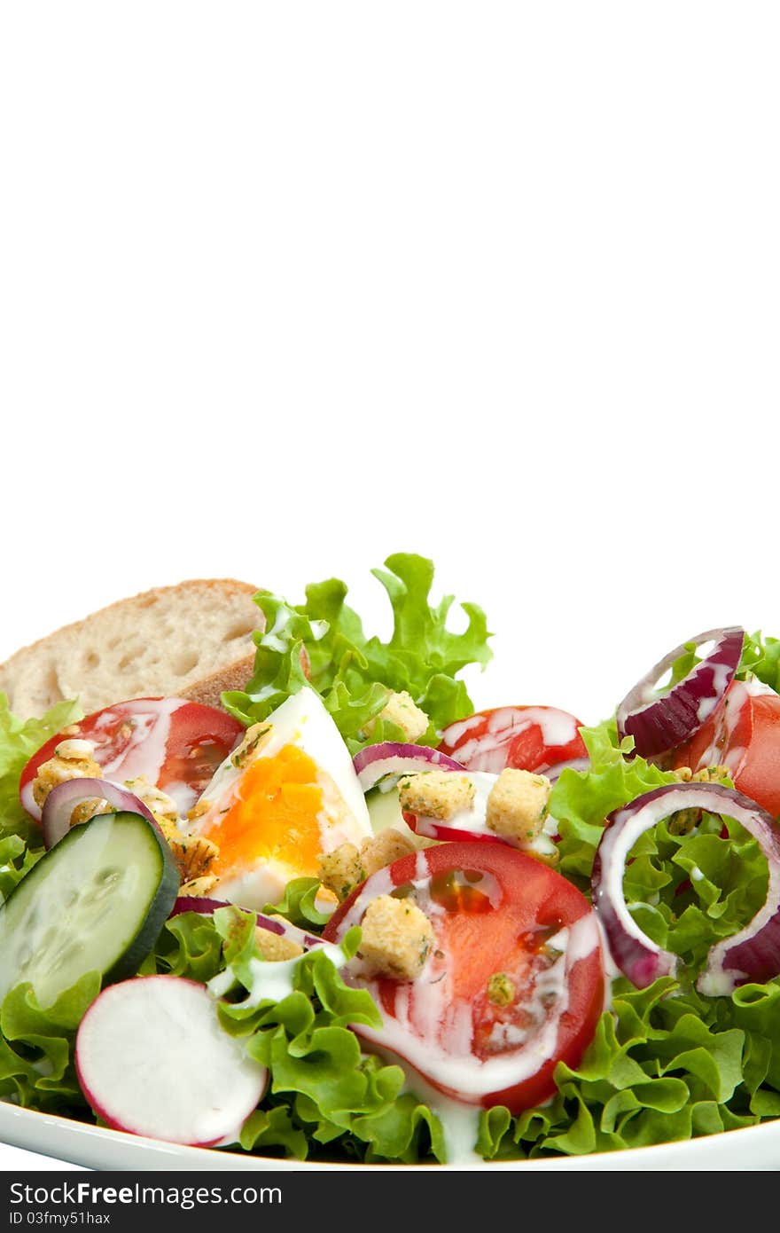 A plate of a complete salad with a white background. A plate of a complete salad with a white background