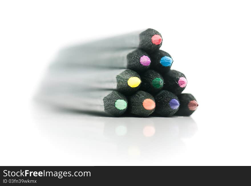Black coloured pencils bundled as pyramid, on white background