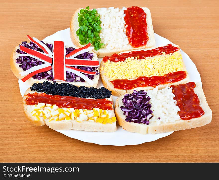 Sandwiches with flags of five countries on plate