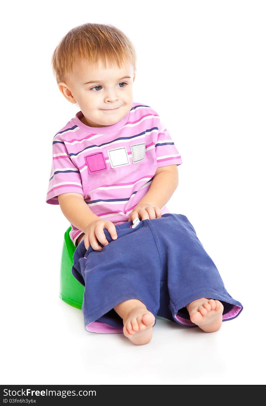 A boy sitting on the pot. Isolated on a white background