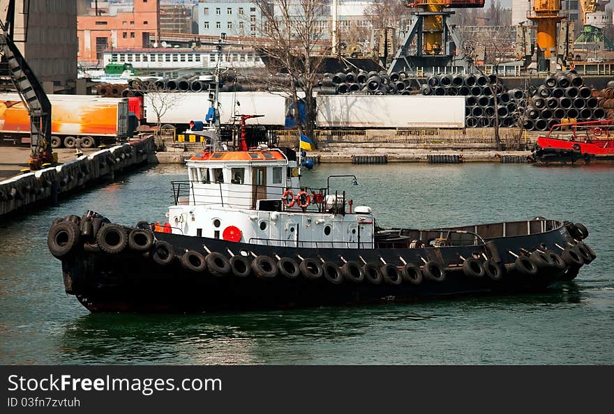 Tug boat in the port near the loading berth