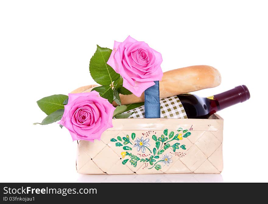 A romantic picnic with roses and wine isolated over white. A romantic picnic with roses and wine isolated over white