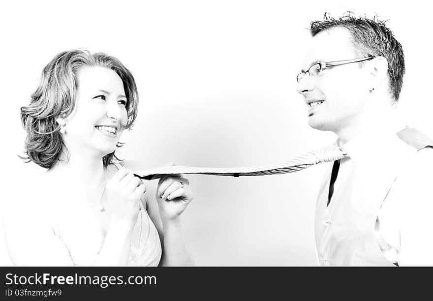 Young Beautiful Happy Couple Playing with the Tie in the Engagement Day in a tender moment