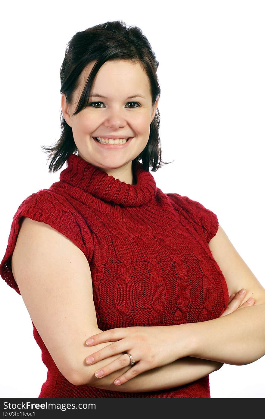 Young adult woman stands confidently with arms folded and a smile on her face