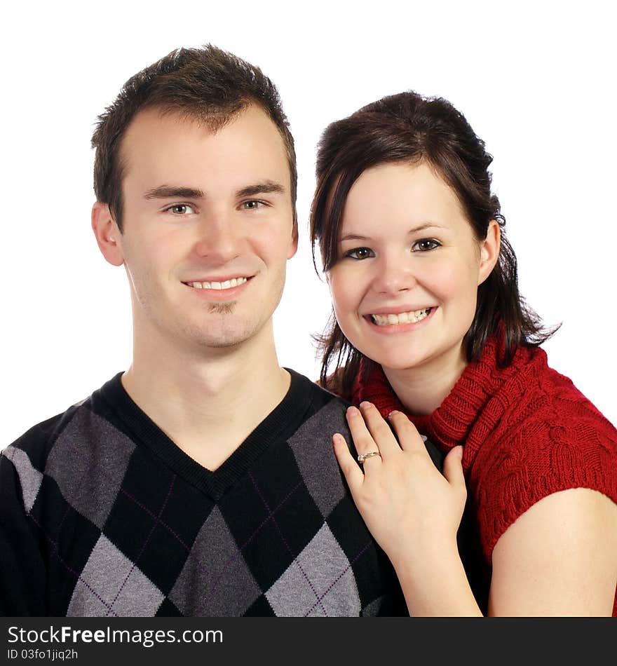 Young couple poses for the camera with wives arms around her husband. Young couple poses for the camera with wives arms around her husband.