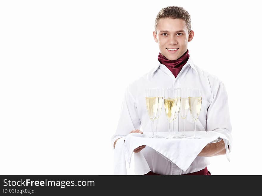 The young waiter with a tray with glasses of champagne on a white background