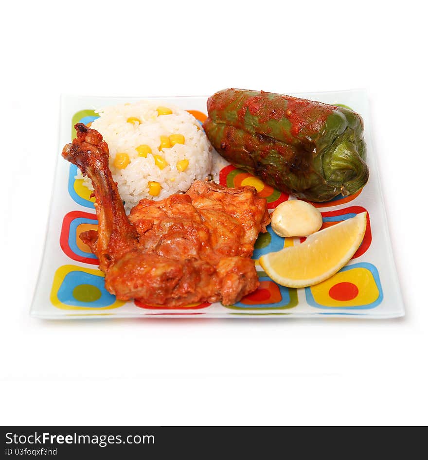 Chicken drumsticks and rice vegetables on color dish