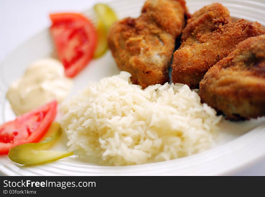 Chicken wing and rice vegetables on white dish