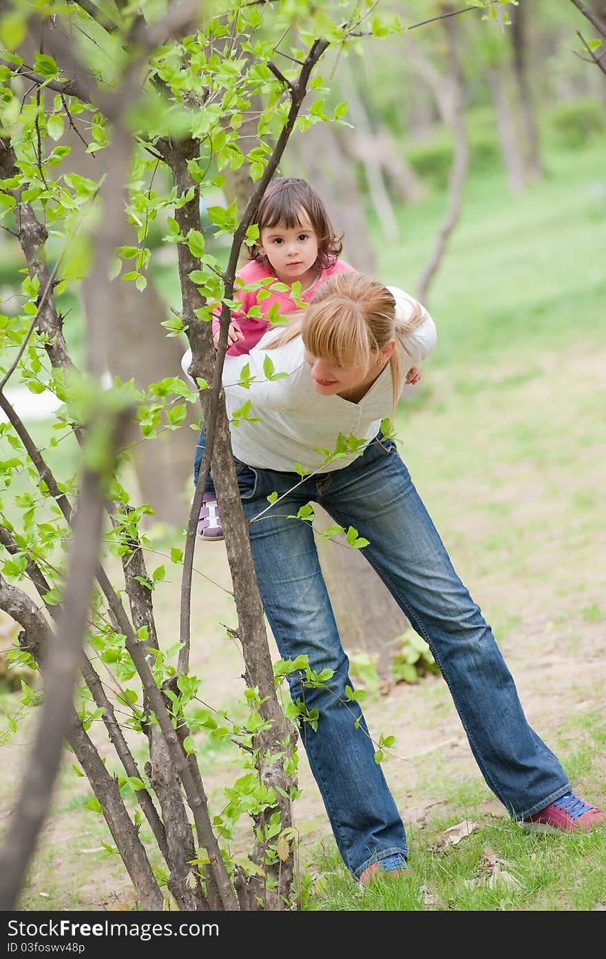 Young Mother Piggybacking Her Daughter