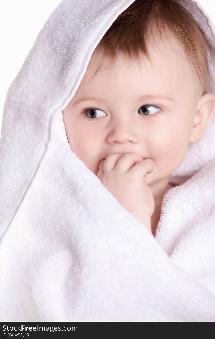 A small child in a white towel. A small child in a white towel