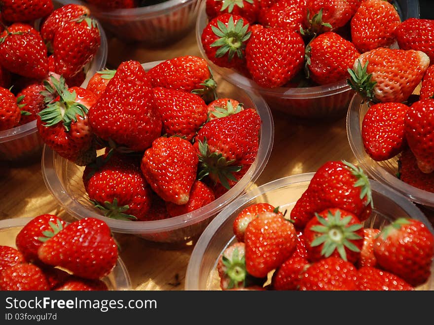 Several plates of fresh strawberry in a market. Several plates of fresh strawberry in a market.