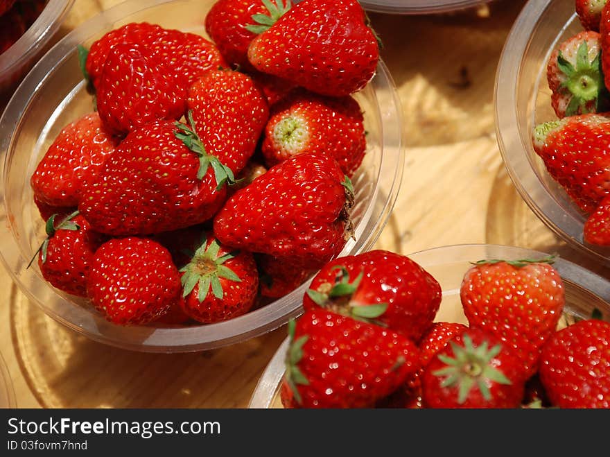 Plates of fresh strawberry in a market