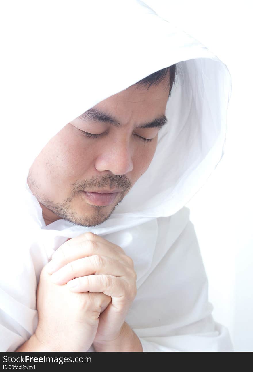 Asian man in white dress is praying. Asian man in white dress is praying