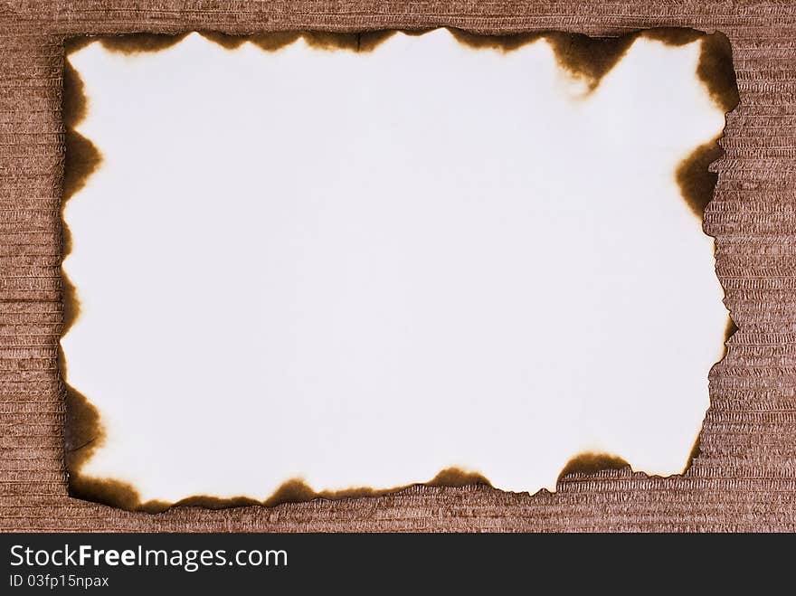 Burned paper on brown background