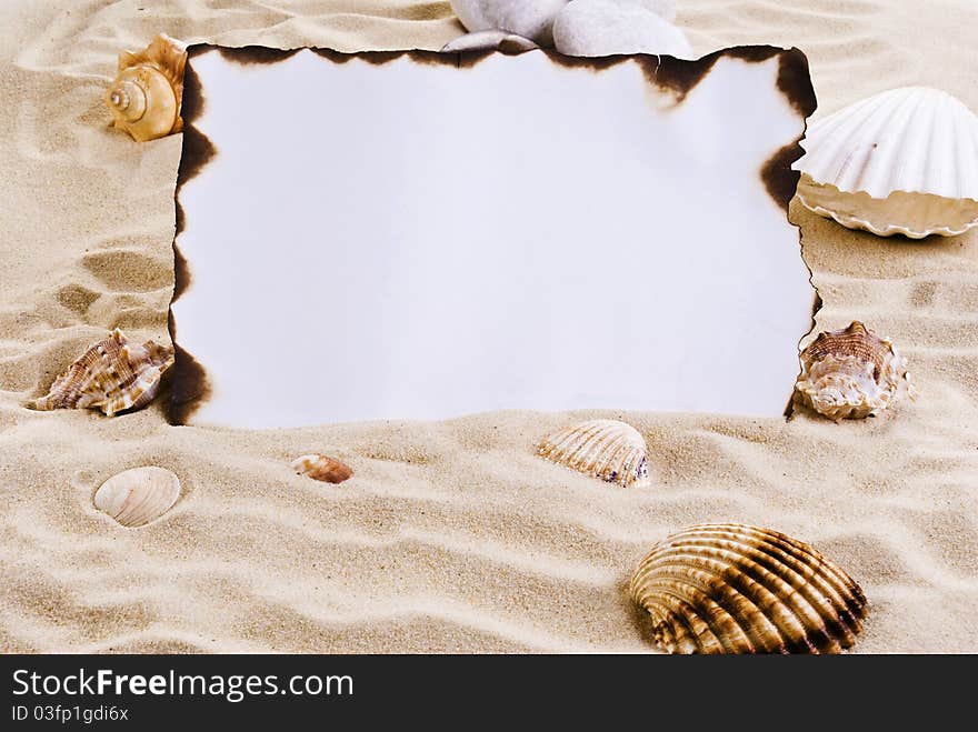 Burned paper on the sand with shells. Burned paper on the sand with shells