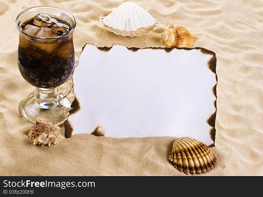 Burned paper on the sand with shells. Burned paper on the sand with shells