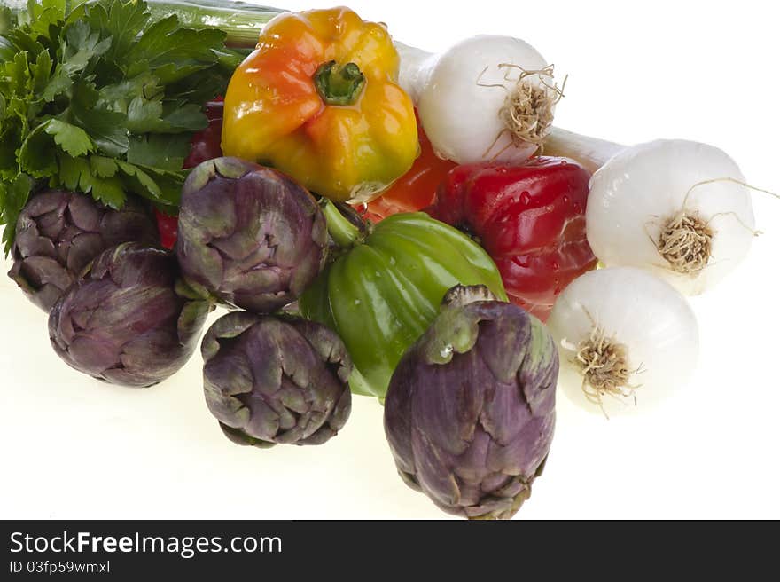 Small exotic peppers and artichokes on a white background