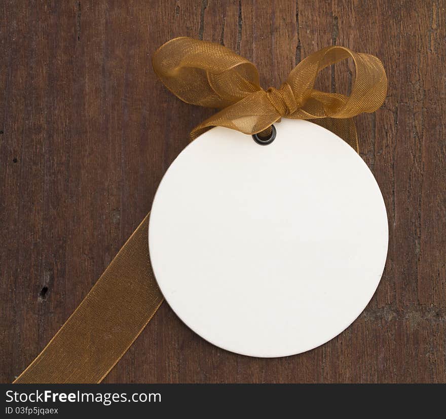 With transparent brown bow on the wooden background. With transparent brown bow on the wooden background