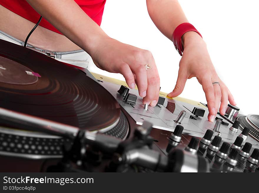 Girl disc jockey adjusting the sound levels on professional mixing controller. Girl disc jockey adjusting the sound levels on professional mixing controller